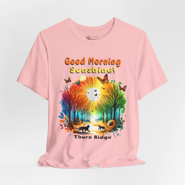 good morning sunshine graphic tee by Thorn Ridge featuring the sun shining through the trees and two cats walking across the path in a park.