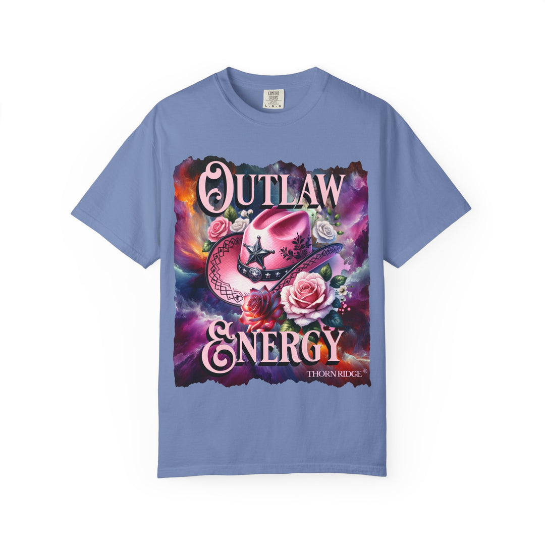 Outlaw Energy graphic tee with a pink cowgirl hat and roses on a celestial background of pinks, blues, and oranges. Labeled Thorn Ridge®