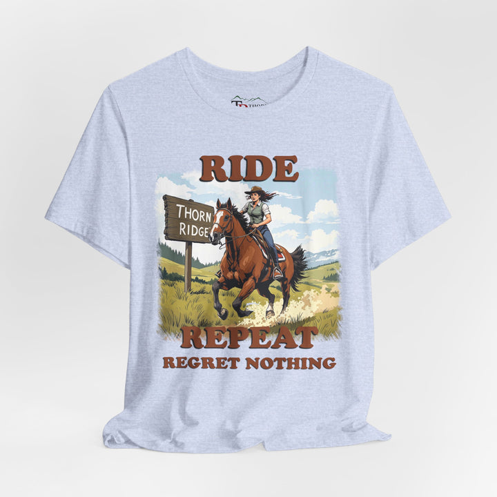 Ride Repeat Regret Nothing tee with a woman riding a galloping horse across the feild with the mountains in the background and a sign labeled Thorn Ridge®