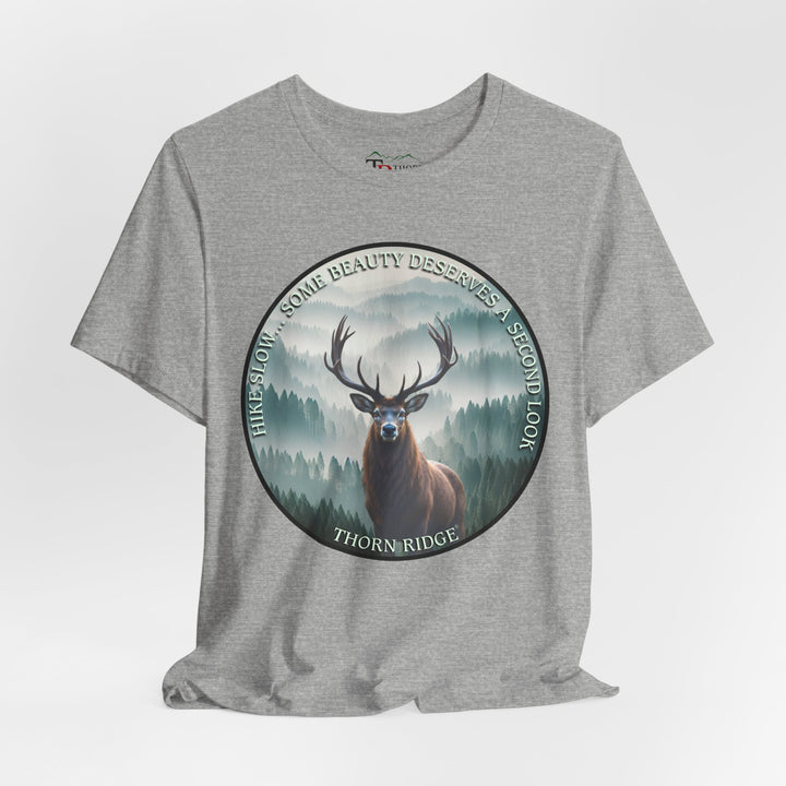 Hike Slow Some Beauty Deserves a Second Look tee with deer and mountains within a circular graphic by Thorn Ridge®