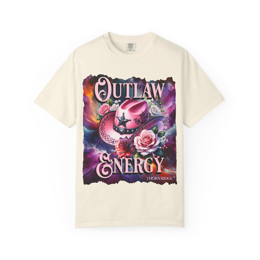 Outlaw Energy graphic tee with a pink cowgirl hat and roses on a celestial background of pinks, blues, and oranges. Labeled Thorn Ridge®