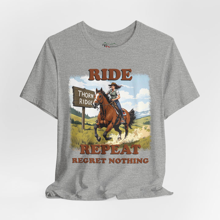 Ride Repeat Regret Nothing tee with a woman riding a galloping horse across the feild with the mountains in the background and a sign labeled Thorn Ridge®