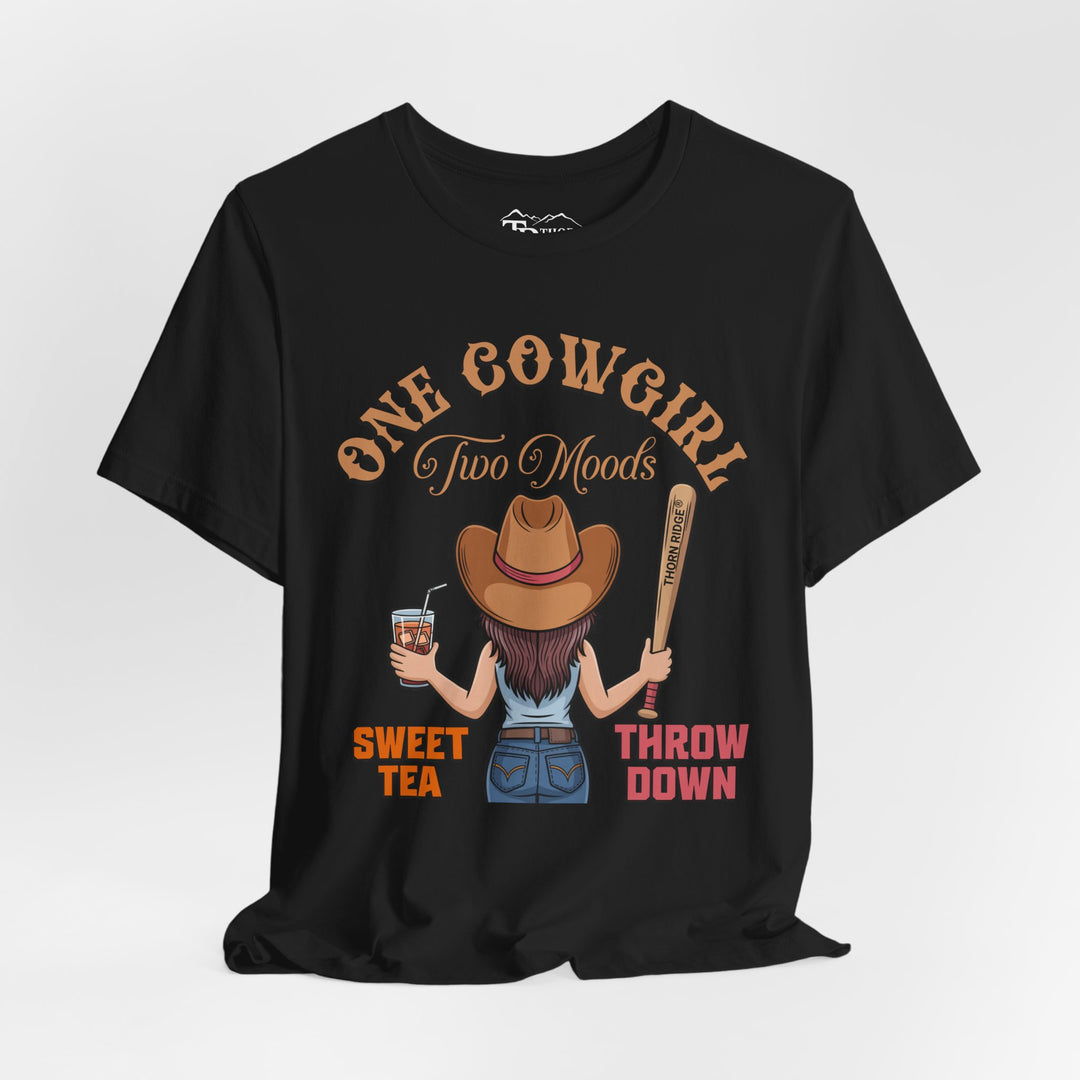 t-shirt with a graphic of a cowgirl holding a drink and a bat, with text 'One Cowgirl Two Moods Sweet Tea Throw Down' labeled Thorn Ridge®