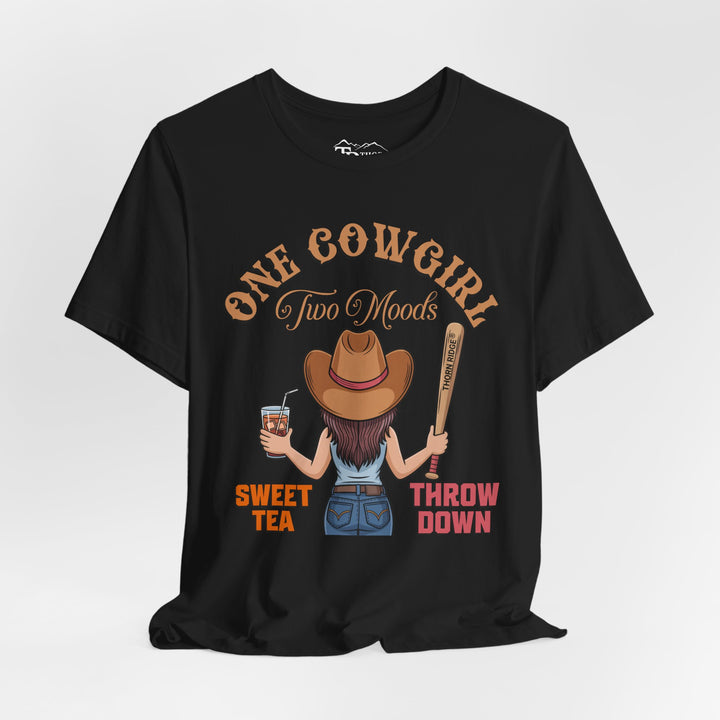 t-shirt with a graphic of a cowgirl holding a drink and a bat, with text 'One Cowgirl Two Moods Sweet Tea Throw Down' labeled Thorn Ridge®