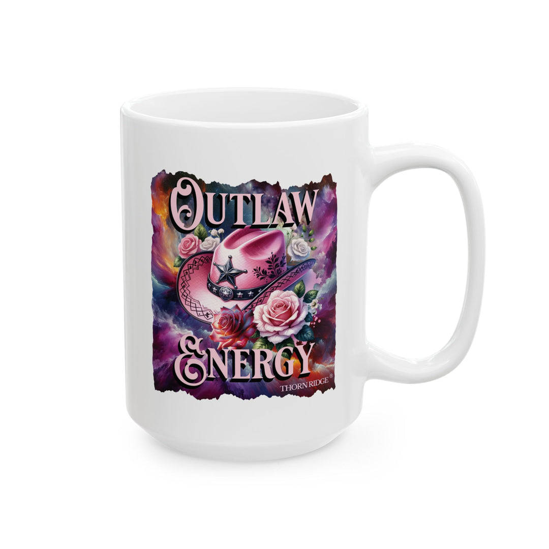 White mug with a colorful design featuring a pink cowboy hat and flowers, labeled 'Outlaw Energy' by Thorn Ridge®