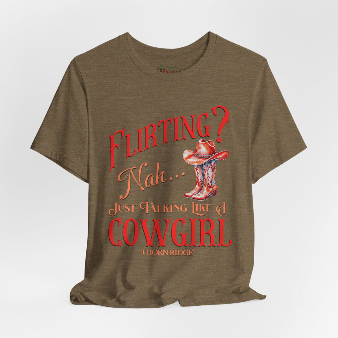 "Flirting? Nah... just talking like a cowgirl" graphic tee with women's cowgirl boots with a cowgirl hat sitting on top. Labeled Thorn Ridge®