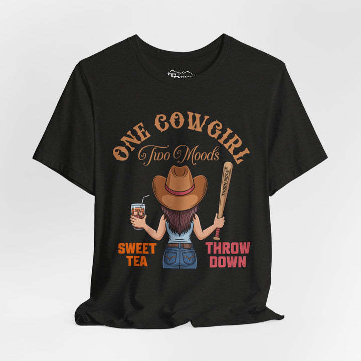 t-shirt with a graphic of a cowgirl holding a drink and a bat, with text 'One Cowgirl Two Moods Sweet Tea Throw Down' labeled Thorn Ridge®