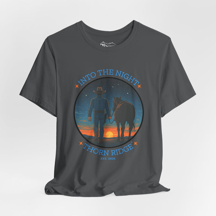 t-shirt with 'Into the Night' and 'Thorn Ridge' graphic design of a cowboy leading his horse into the setting sun as night is falling.