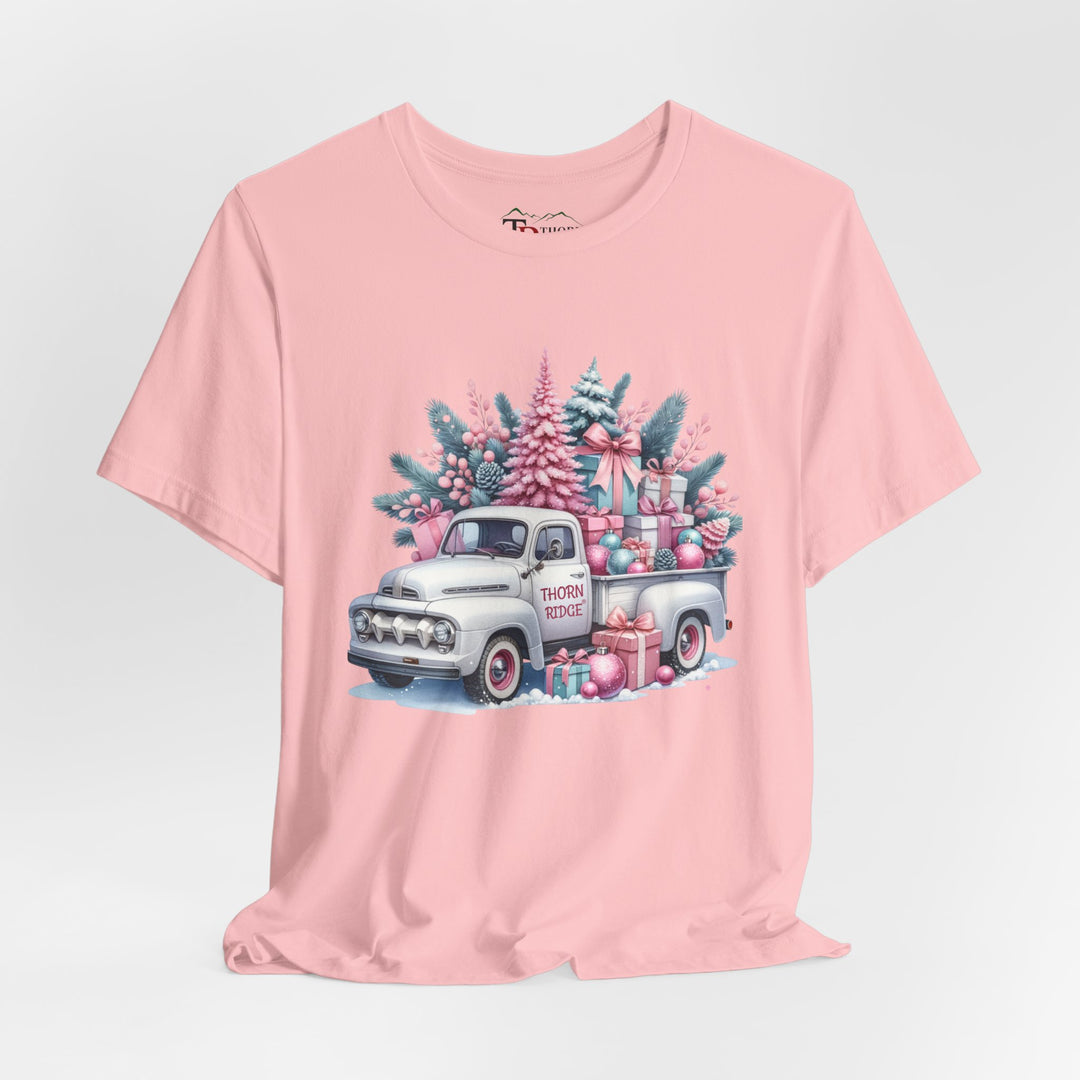 t-shirt with a vintage white truck with the bed filled with pastel colored christmas trees and presents with Thorn ridge on the driver's side door and presents around the door on the ground. 