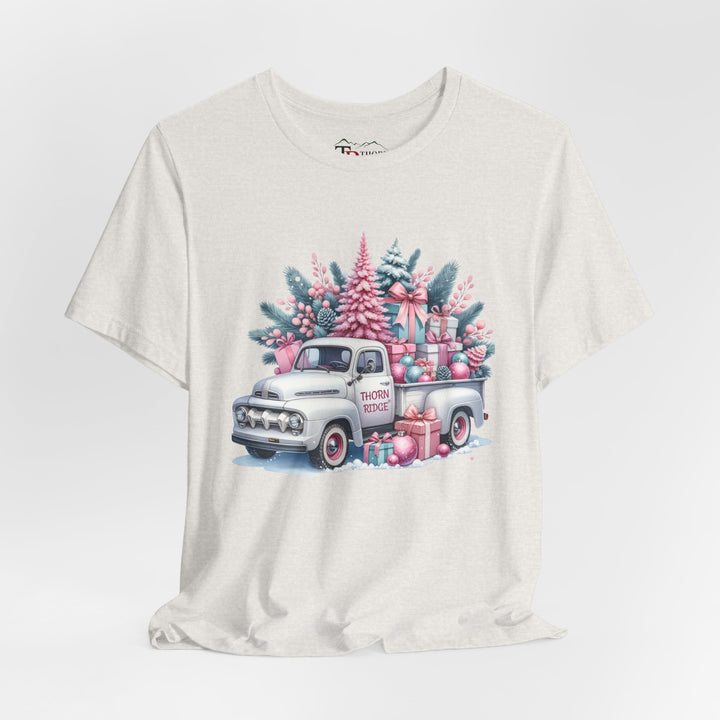 t-shirt with a vintage white truck with the bed filled with pastel colored christmas trees and presents with Thorn ridge on the driver's side door and presents around the door on the ground. 