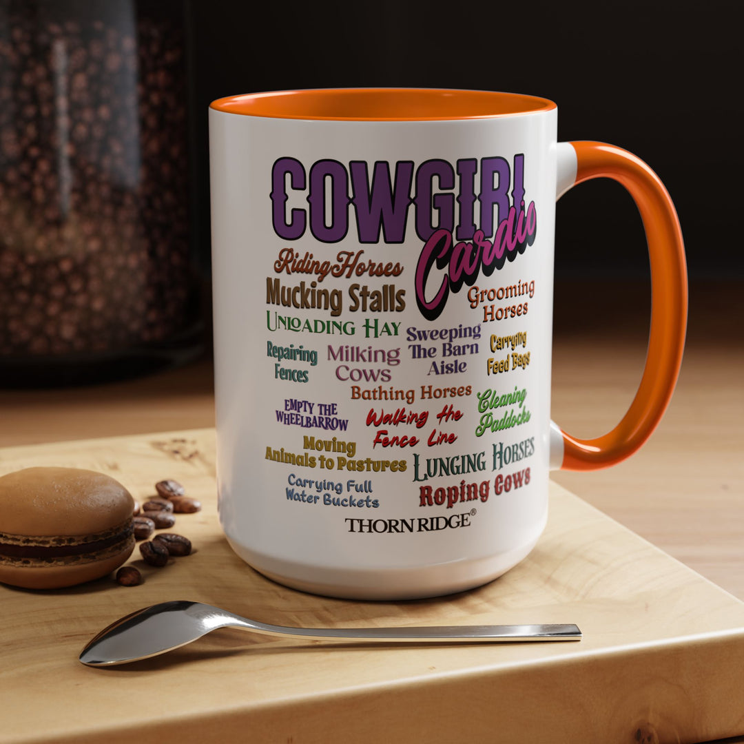 Mug with 'Cowgirl Cardio' text and orange handle on a white background