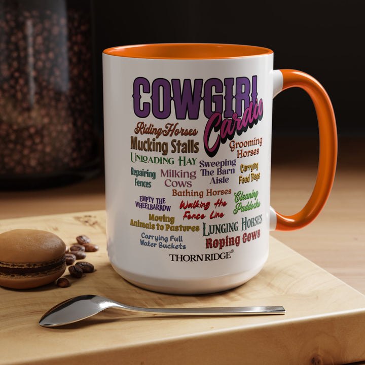 Mug with 'Cowgirl Cardio' text and orange handle on a white background
