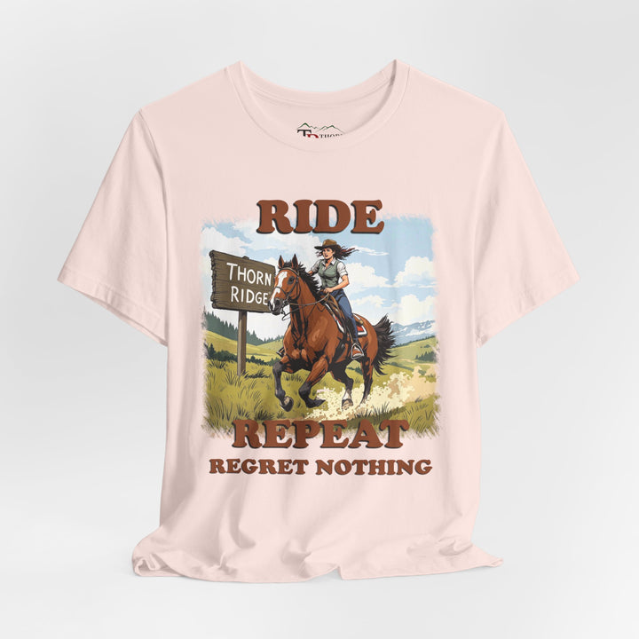Ride Repeat Regret Nothing tee with a woman riding a galloping horse across the feild with the mountains in the background and a sign labeled Thorn Ridge®