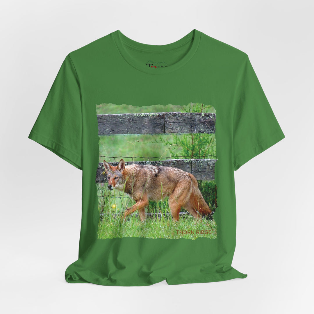 t-shirt with a photo of a red coyote against a weathered board fence and green grass labeled Thorn Ridge®