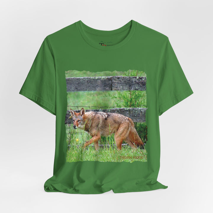 t-shirt with a photo of a red coyote against a weathered board fence and green grass labeled Thorn Ridge®