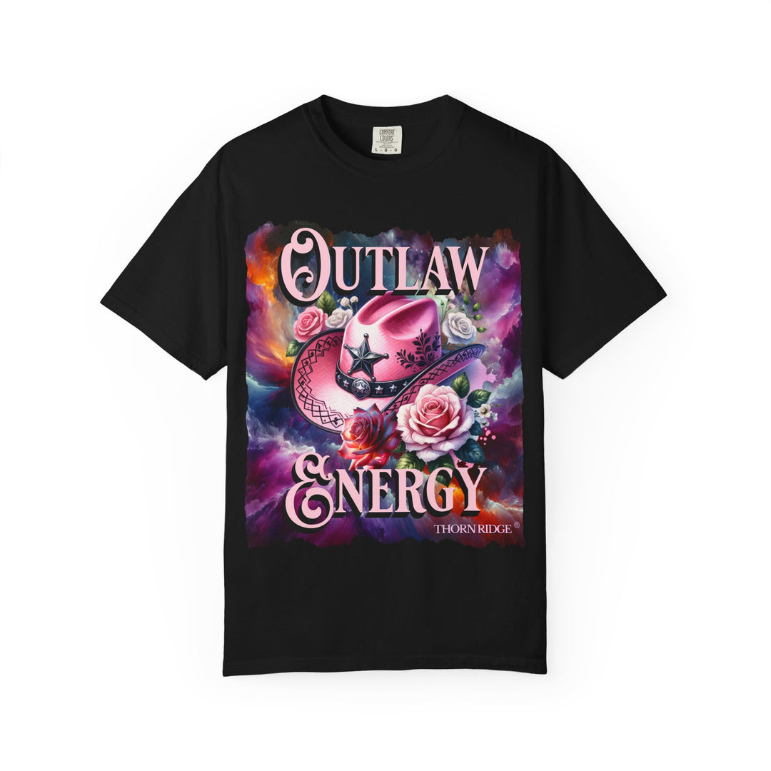 Outlaw Energy graphic tee with a pink cowgirl hat and roses on a celestial background of pinks, blues, and oranges. Labeled Thorn Ridge®