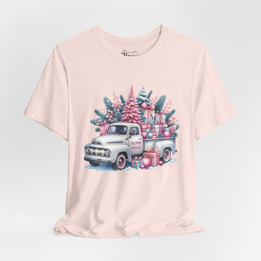 t-shirt with a vintage white truck with the bed filled with pastel colored christmas trees and presents with Thorn ridge on the driver's side door and presents around the door on the ground.  