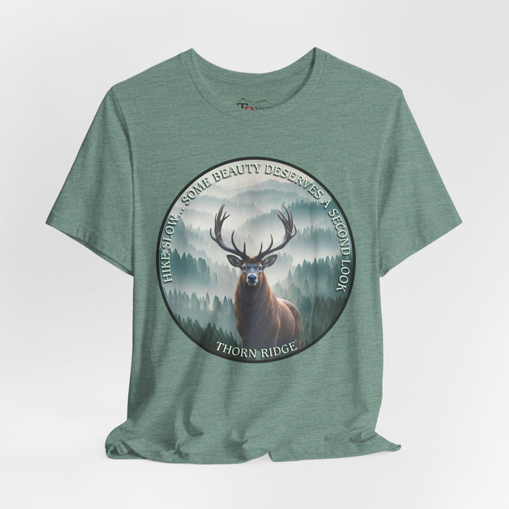 Hike Slow Some Beauty Deserves a Second Look tee with deer and mountains within a circular graphic by Thorn Ridge®
