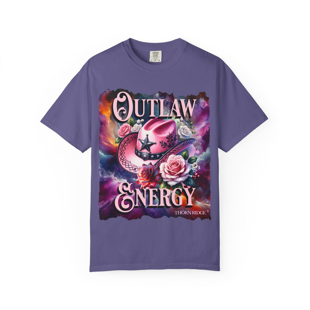 Outlaw Energy graphic tee with a pink cowgirl hat and roses on a celestial background of pinks, blues, and oranges. Labeled Thorn Ridge®