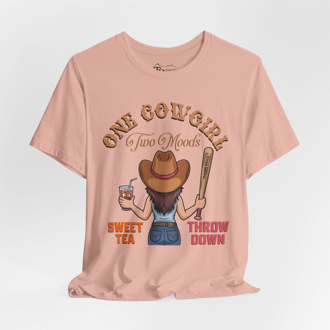 t-shirt with a graphic of a cowgirl holding a drink and a bat, with text 'One Cowgirl Two Moods Sweet Tea Throw Down' labeled Thorn Ridge®