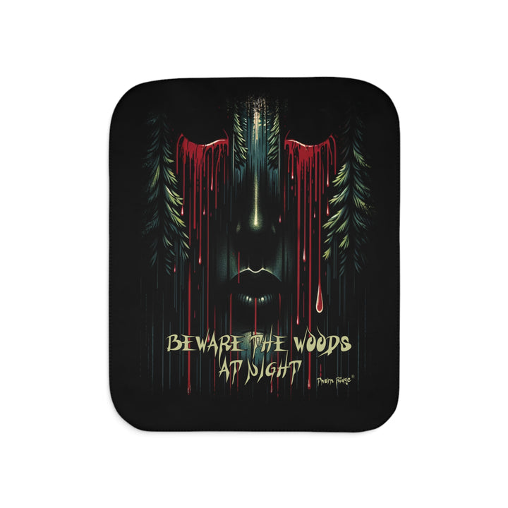 Beware the Woods at Night Sherpa Blanket. A semi-hidden face with bleeding eyes flanked by pine trees.