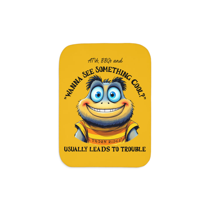Wanna See Something Cool illustration with a big eyes wide smiled character on a yellow Sherpa Blanket with 'Thorn Ridge' branding. 