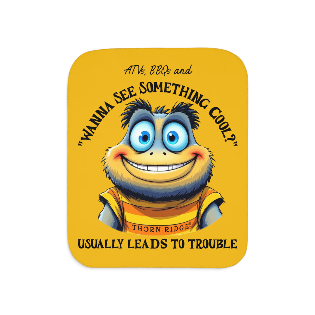 Wanna See Something Cool illustration with a big eyes wide smiled character on a yellow Sherpa Blanket with 'Thorn Ridge' branding. 