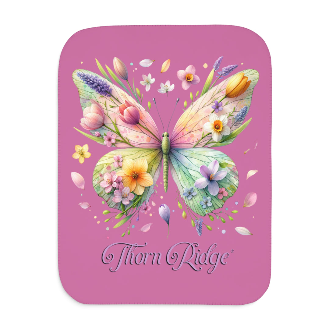 Butterfly design with flowers on a pink Sherpa blanket branded Thorn Ridge