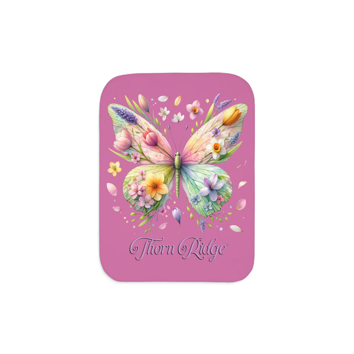 Butterfly design with flowers on a pink Sherpa blanket branded Thorn Ridge