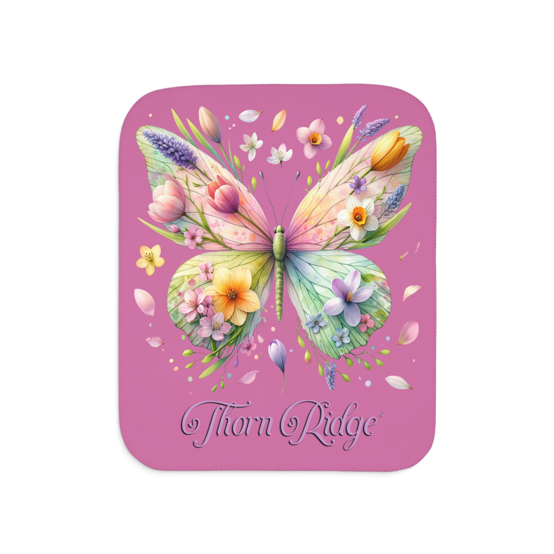 Butterfly design with flowers on a pink Sherpa blanket branded Thorn Ridge