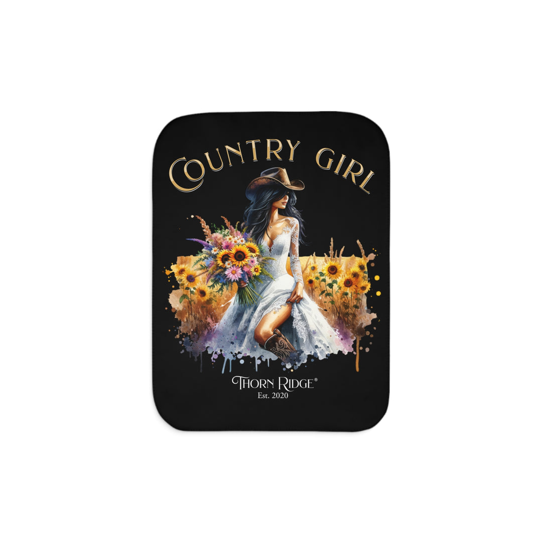 Decorative black sherpa blanket with a Country Girl design featuring a woman, flowers, and the Thorn Ridge logo.