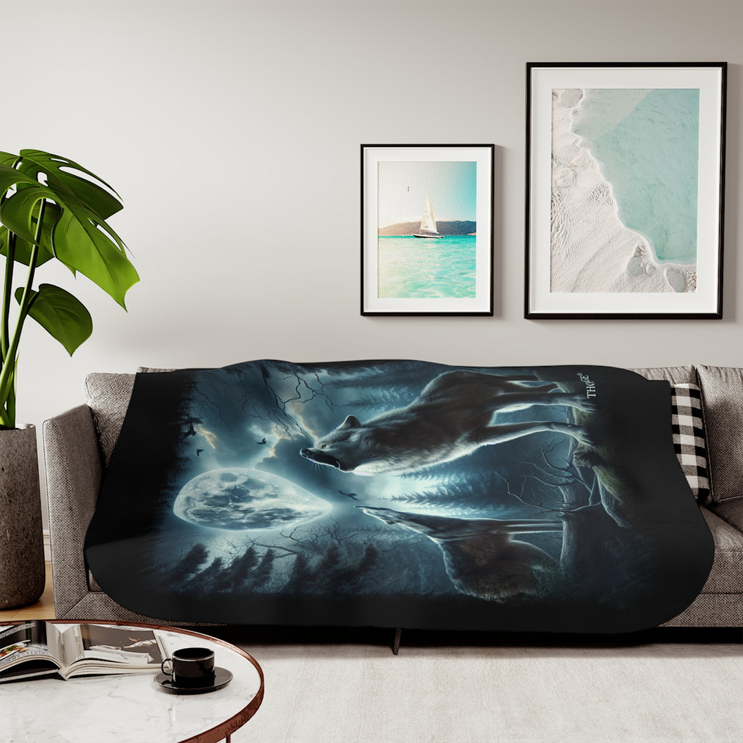 Moonlit Wolves sherpa blanket by Thorn Ridge® featuring two gray wolves deep in the forest howling at the moon with black birds flying around in the sky.