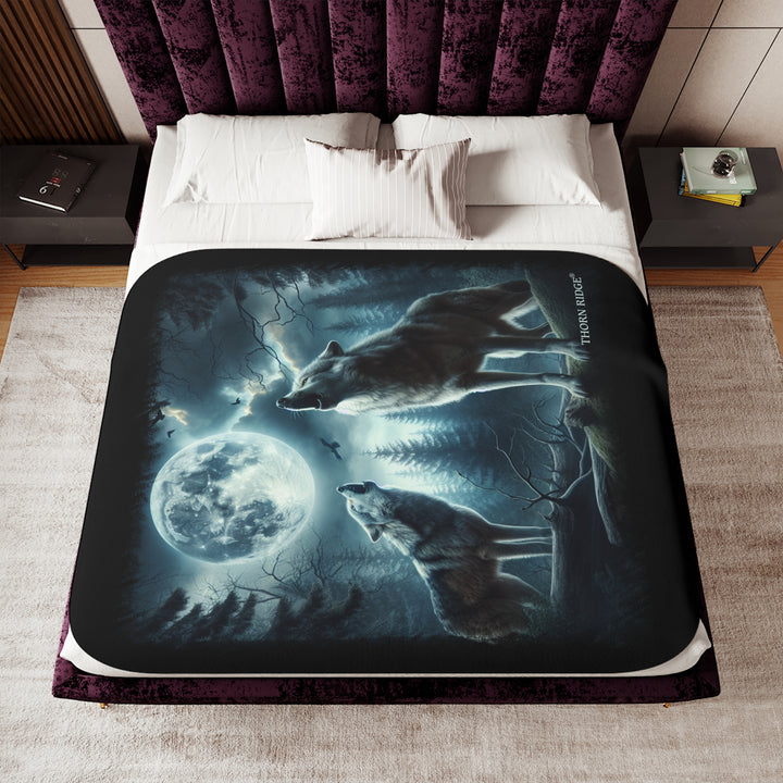 Moonlit Wolves sherpa blanket by Thorn Ridge® featuring two gray wolves deep in the forest howling at the moon with black birds flying around in the sky.