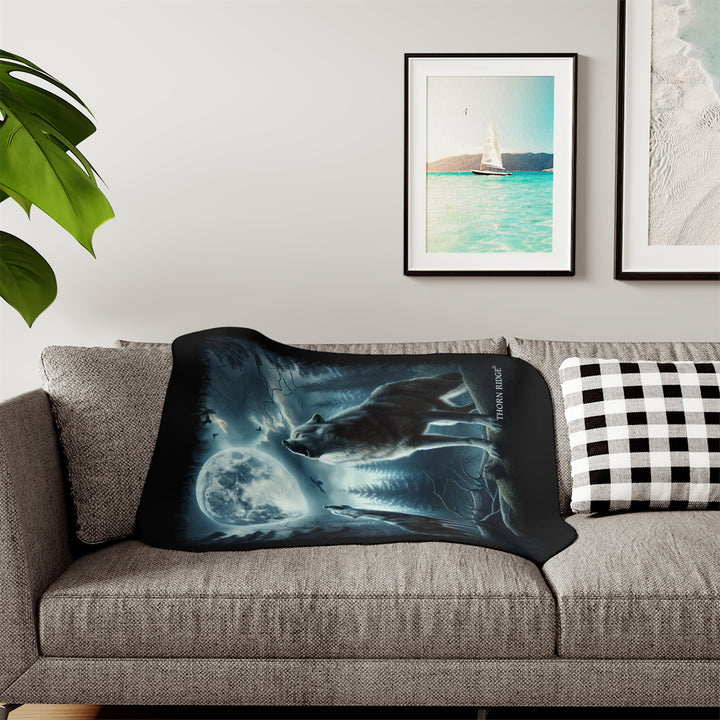 Moonlit Wolves sherpa blanket by Thorn Ridge® featuring two gray wolves deep in the forest howling at the moon with black birds flying around in the sky.