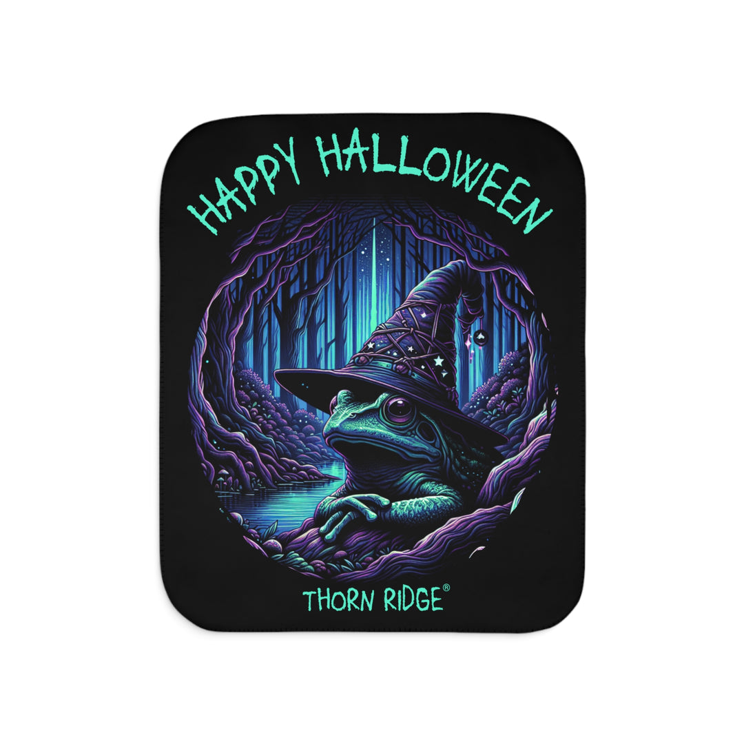 Happy Halloween black sherpa blanket with an image of the Frog Witch wearing a witch hat sitting by the creek by Thorn Ridge®