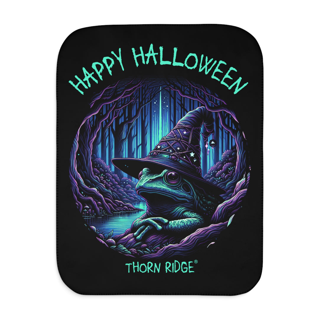 Happy Halloween black sherpa blanket with an image of the Frog Witch wearing a witch hat sitting by the creek by Thorn Ridge®