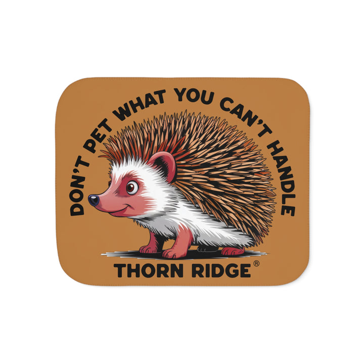 Light brown sherpa blanket with hedgehog illustration and text 'Don't pet what you can't handle' by Thorn Ridge®.