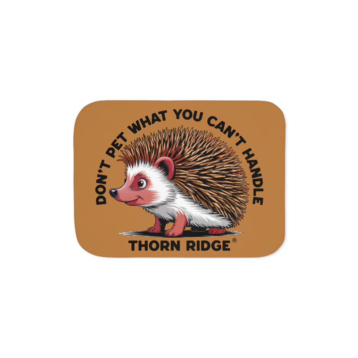Light brown sherpa blanket with hedgehog illustration and text 'Don't pet what you can't handle' by Thorn Ridge®.