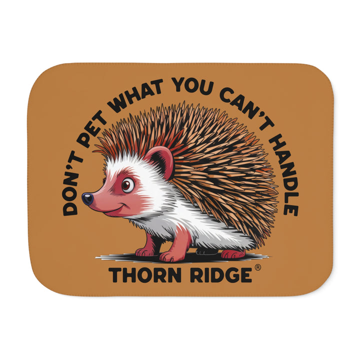 Light brown sherpa blanket with hedgehog illustration and text 'Don't pet what you can't handle' by Thorn Ridge®.