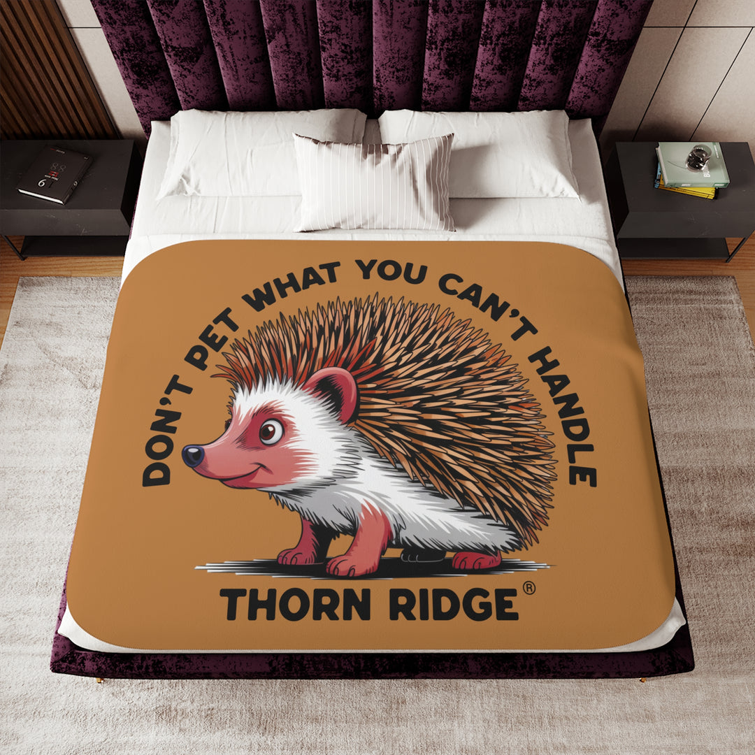 Light brown sherpa blanket with hedgehog illustration and text 'Don't pet what you can't handle' by Thorn Ridge®.