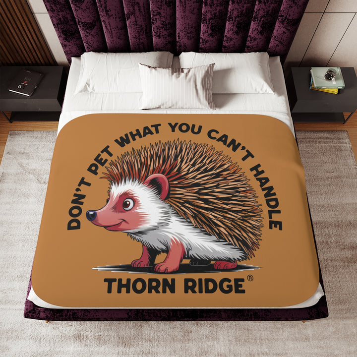 Light brown sherpa blanket with hedgehog illustration and text 'Don't pet what you can't handle' by Thorn Ridge®.
