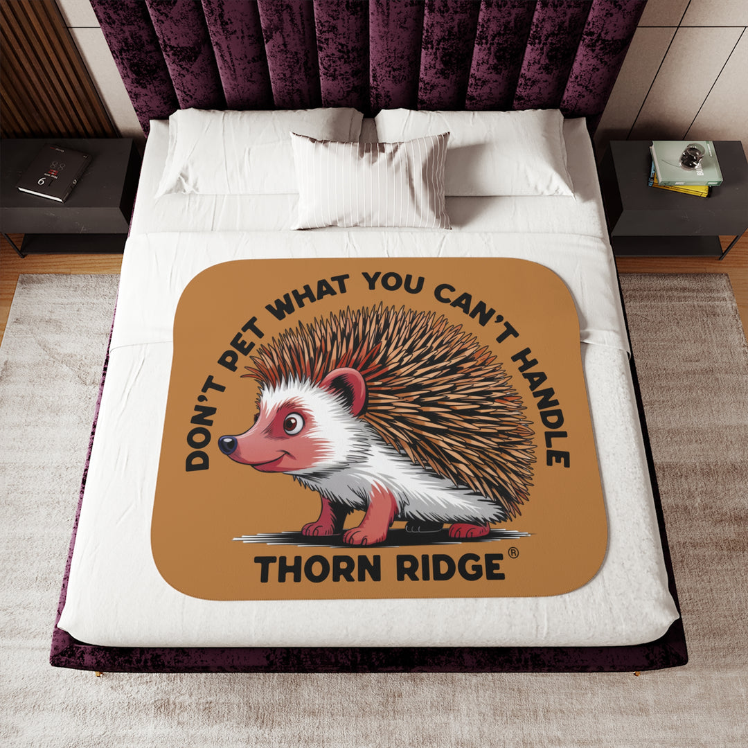 Light brown sherpa blanket with hedgehog illustration and text 'Don't pet what you can't handle' by Thorn Ridge®.