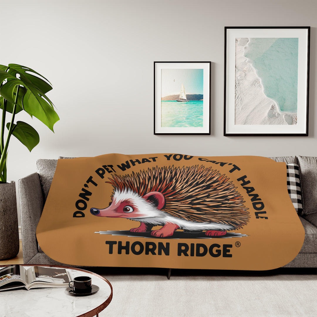 Light brown sherpa blanket with hedgehog illustration and text 'Don't pet what you can't handle' by Thorn Ridge®.