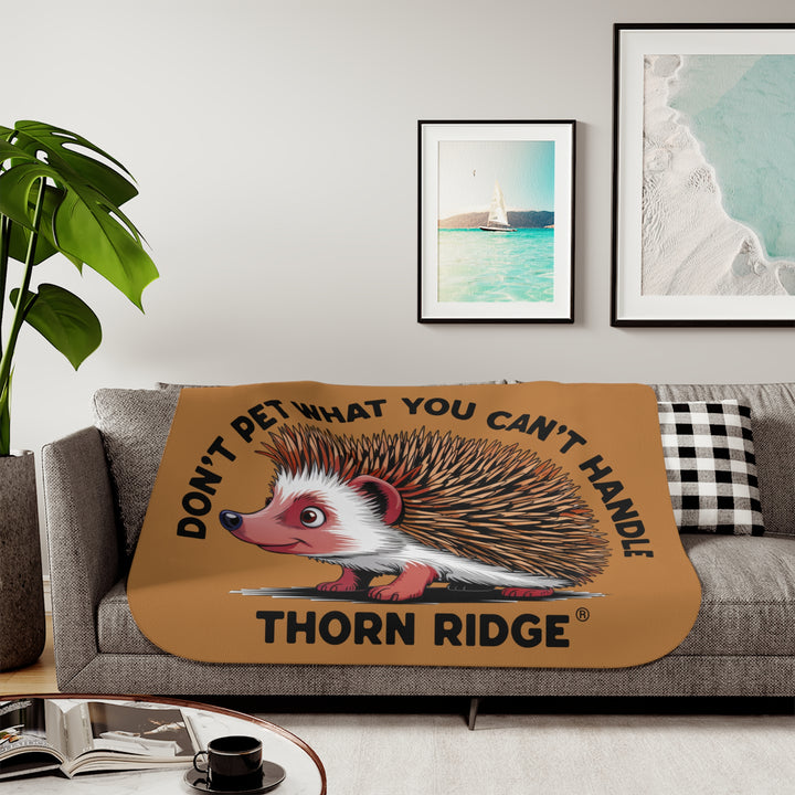 Light brown sherpa blanket with hedgehog illustration and text 'Don't pet what you can't handle' by Thorn Ridge®.