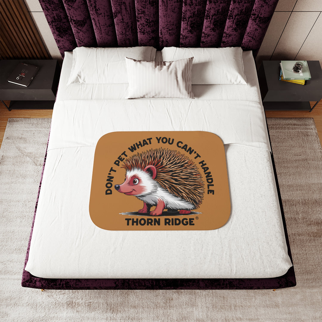 Light brown sherpa blanket with hedgehog illustration and text 'Don't pet what you can't handle' by Thorn Ridge®.