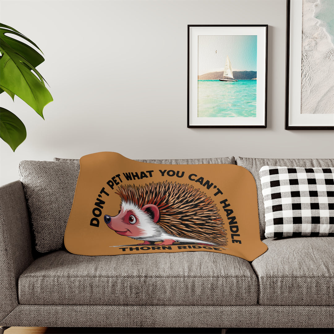 Light brown sherpa blanket with hedgehog illustration and text 'Don't pet what you can't handle' by Thorn Ridge®.