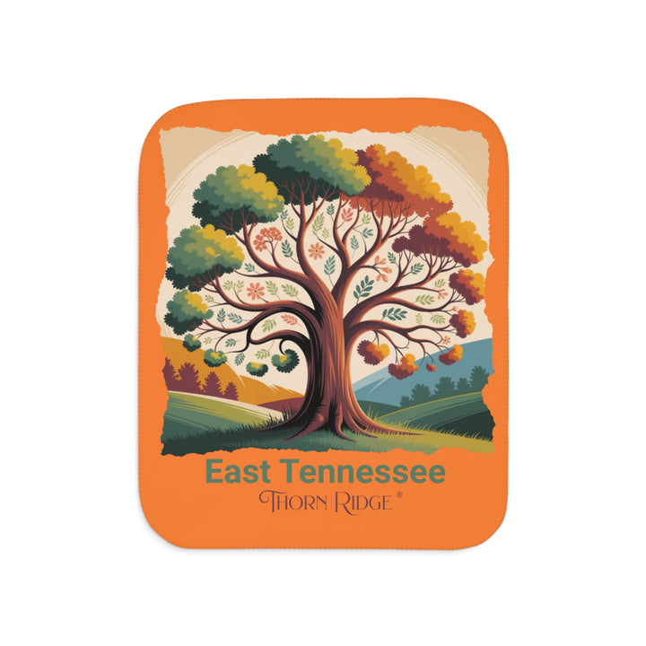 Orange sherpa blanket with an autumn tree design and East Tennessee and branded Thorn Ridge®