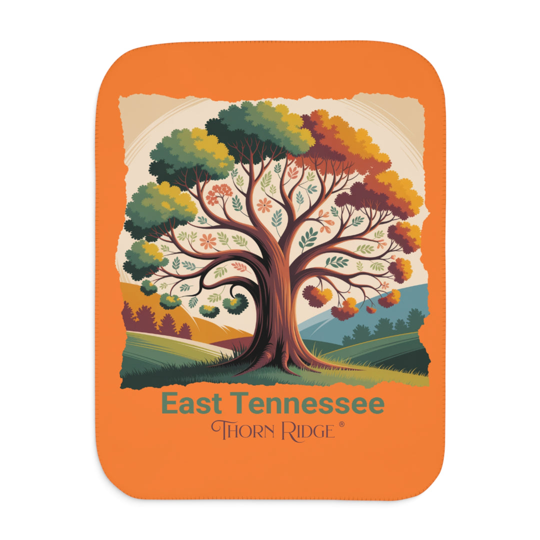 Orange sherpa blanket with an autumn tree design and East Tennessee and branded Thorn Ridge®