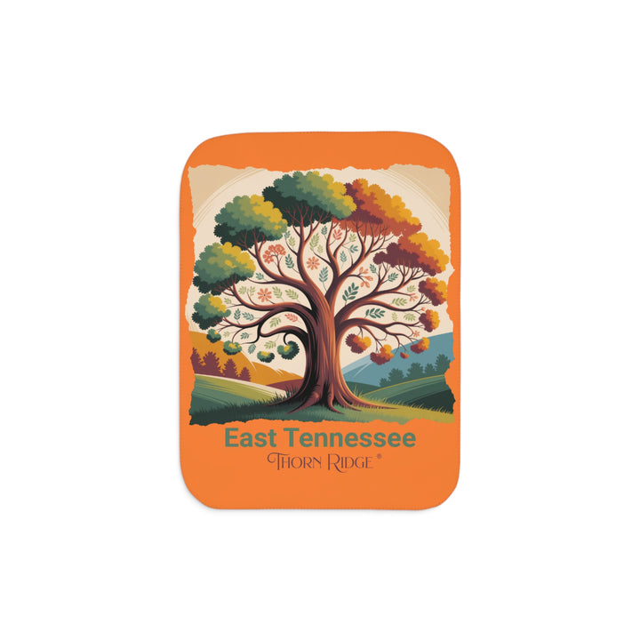 Orange sherpa blanket with an autumn tree design and East Tennessee and branded Thorn Ridge®