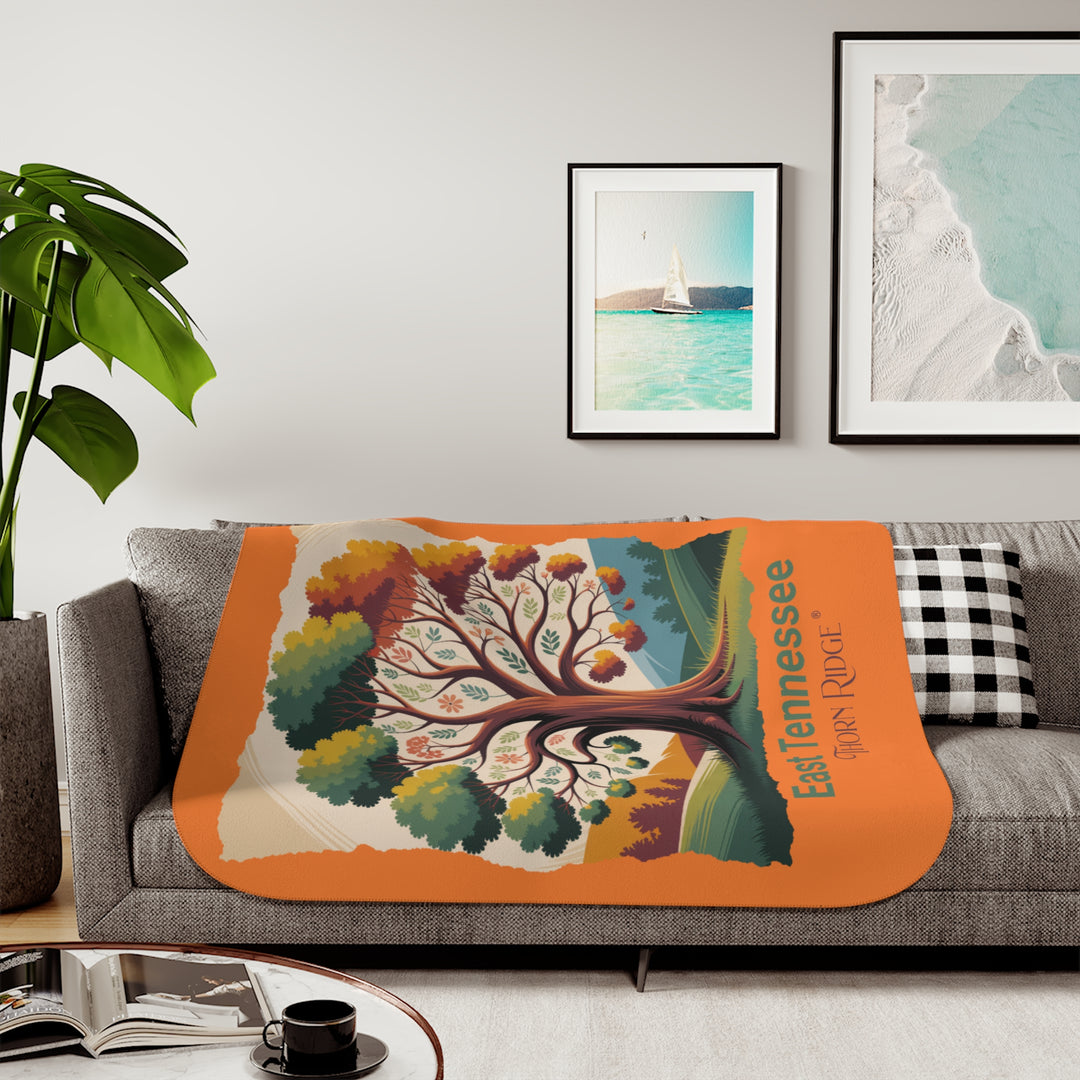 Orange sherpa blanket with an autumn tree design and East Tennessee and branded Thorn Ridge®